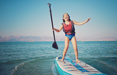 kid on paddleboard having a blast