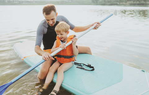 parent and kid paddleboarding
