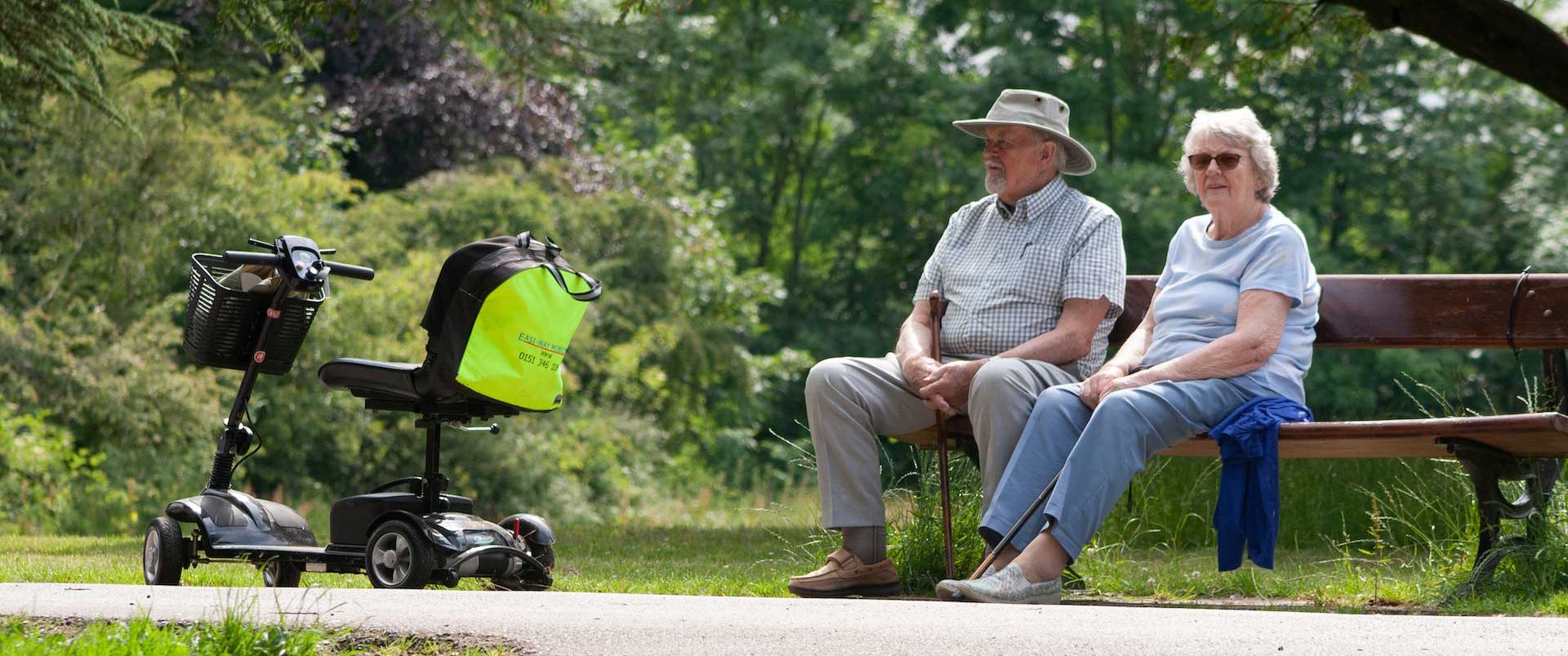 mobility scooter with people on bench