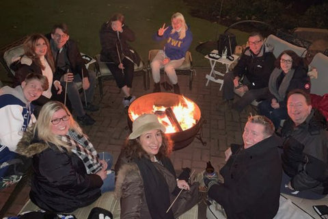 Laughing Group Gathered Around Fire Pit with Smores
