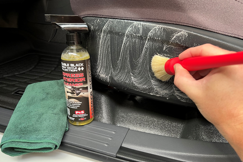cleaning car interior using brush