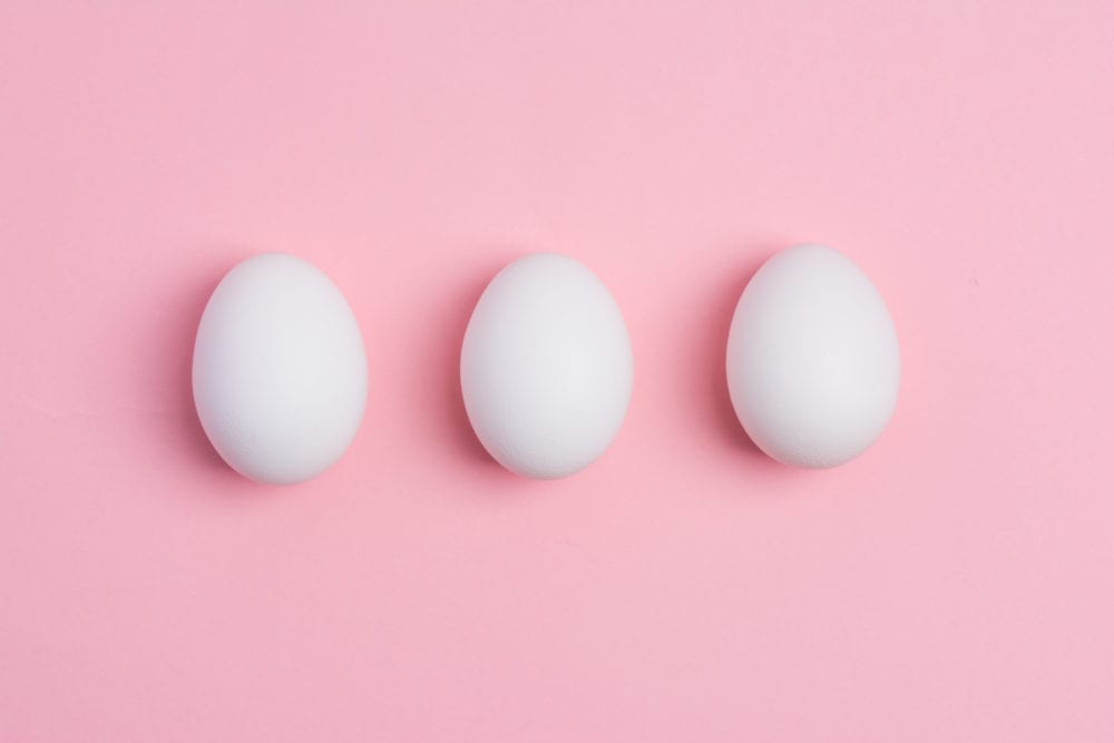 How to get birth control in college: a photo of white eggs on pink background.