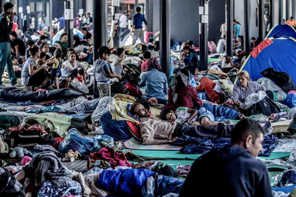 A photo of a crowded informal temporary migrant camp. The closeness of people infers that a number of migrant health issues could emerge due to overcrowding.