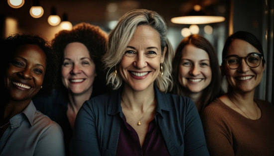 Ways to ensure equality in the workplace: a group of five happy smiling diverse women looking at the camera. 