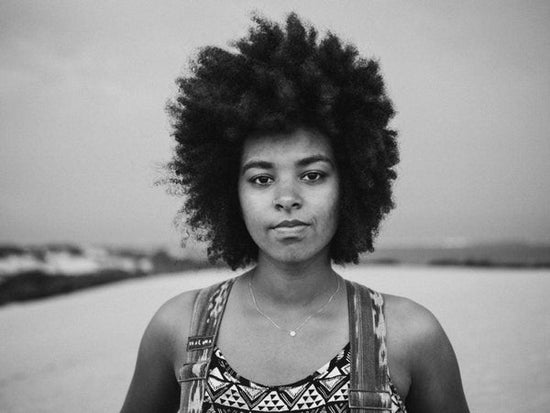 Photo for an article:how to avoid burnout at college? black and white photo of person with a cool funky afro looks straight on camera.