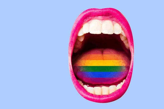 Photo for article on LGBT health care discrimination: An open mouth with bright pink lipstick and the rainbow painted on the tongue screams angst.
