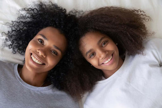 My daughter has depression: a photo of a mother and her daughter lying on a bed together.