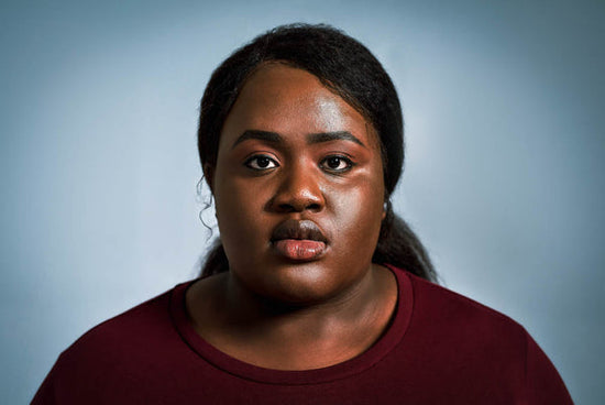 A portrait of a Black woman staring intently at the camera. Image for article on 