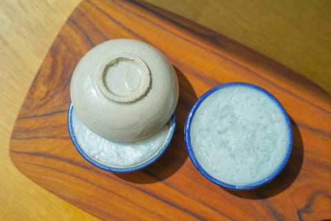Traditional tiny clay bowls to steam the khamon thuay aka coconut and pandan custard 