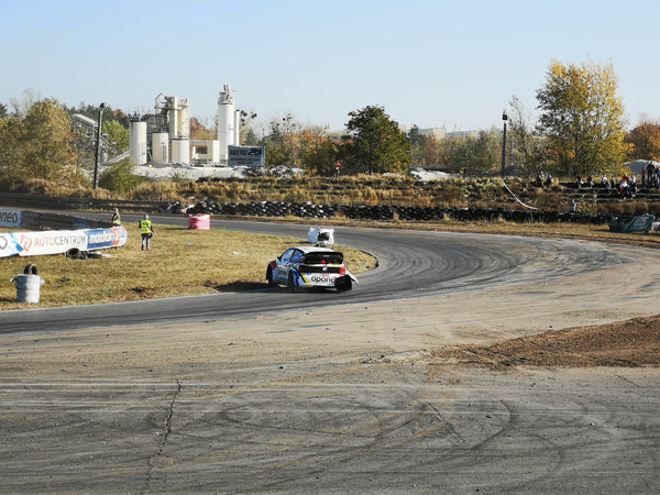 Damaged car slides through high speed corner at Oponeo RallyCross event in Torun Poland