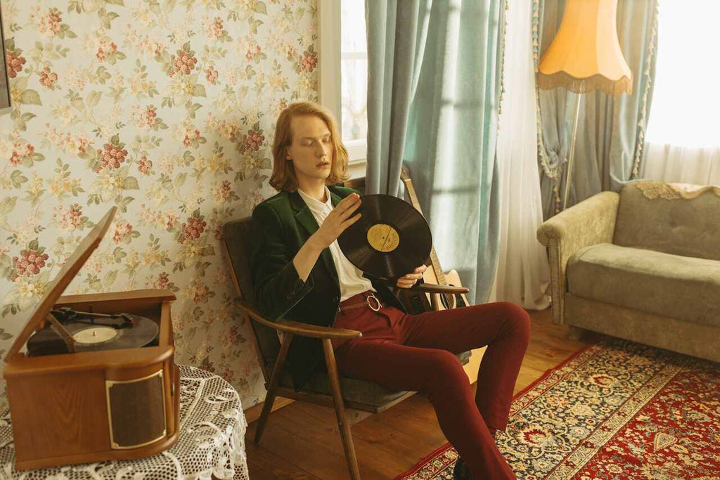 A vinyl enthusiast holding a record
