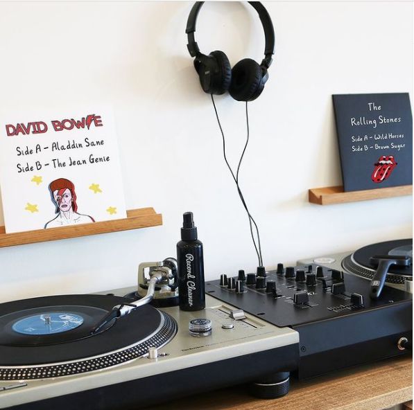 Record players and vinyl records on display with custom record jackets from Big Fudge 