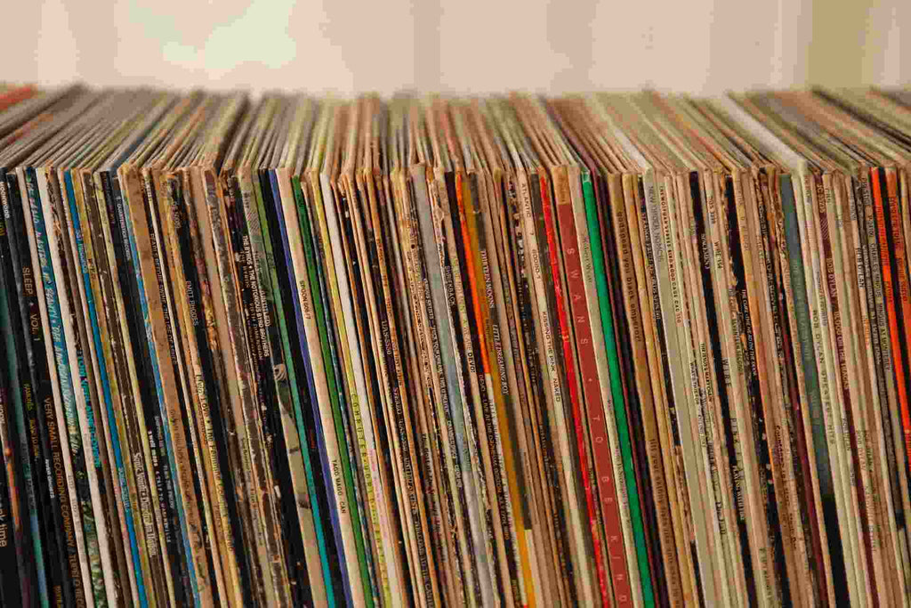 a row of multicolored records stacked side by side