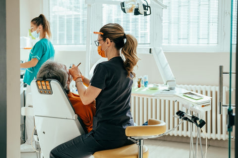 A dentist with her assistant during a patient’s dental surgery