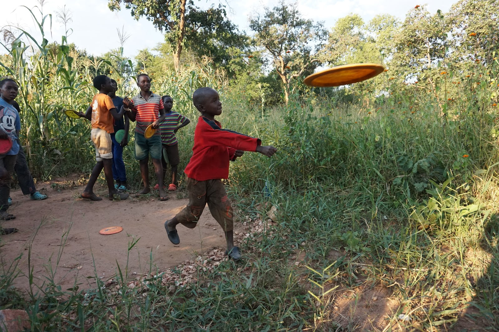 Kids in Zambia playing disc golf