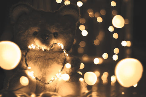 Gray teddy bear with small lightning lamps.