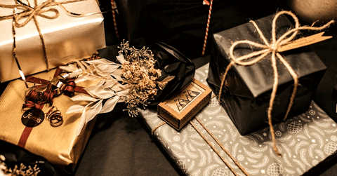 Gifts wrapped in black and gold wrapping paper.