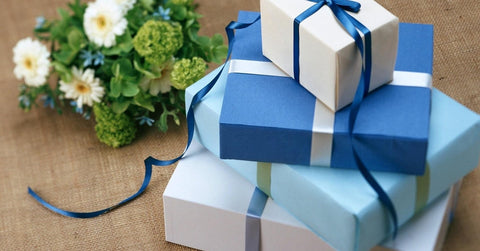 Gift boxes wrapped in white and blue paper