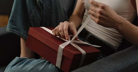 a person opening a housewarming gift