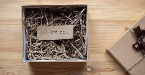 cardboard gift box with a postcard on the table