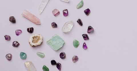 Various crystals against a pink background.