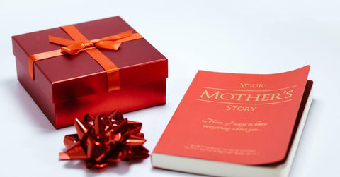 Red gift box and a book on the table