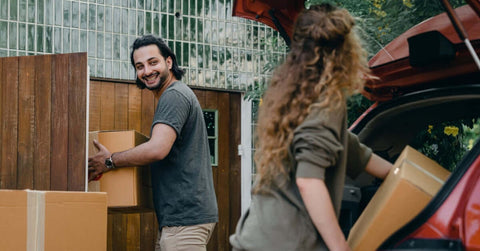 People unpacking boxes from a car