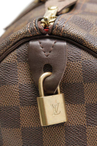 where does the lock go on a louis vuitton speedy