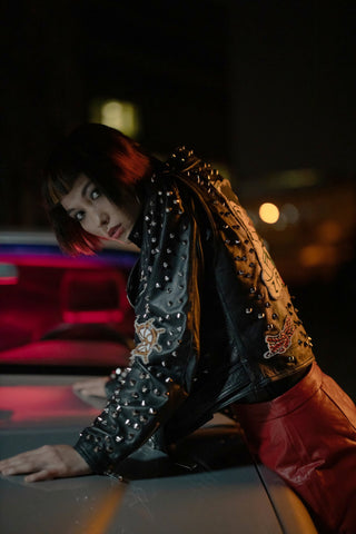 Girl posing with a leather studded jacket and red leather bottoms