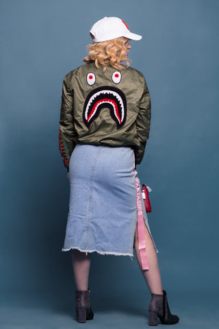 Photo of woman back with a graphic bomber jacket and denim midi skirt