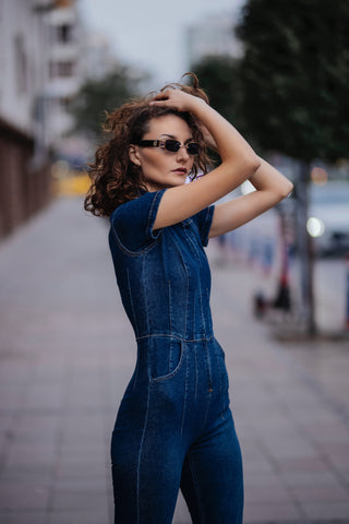 Woman posing with a fitted denim jumpsuit