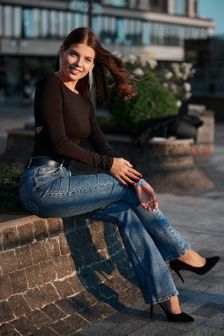 Woman posing in jeans and black high heels