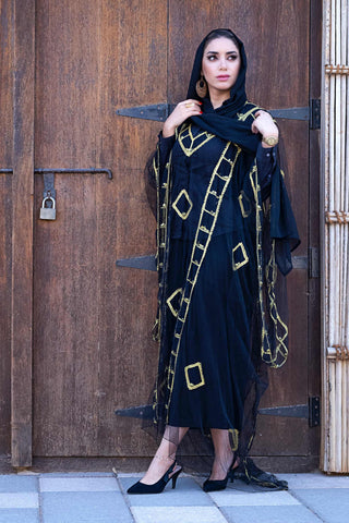 Woman posing in black chikankari kurta outfit and mules