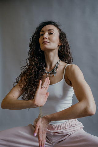 Yogi woman posing in tank top and sweatpants