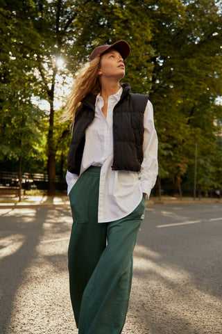 Woman posing in wide-leg pants and a vest