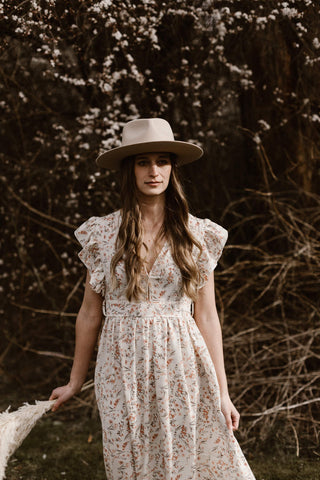 Photo of a woman wearing a boho maxi dress and a hat