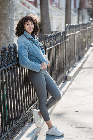 Woman wearing leggings and a short sporty jacket