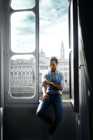 Man posing with jeans and light blue button-up