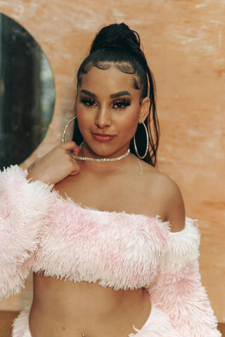 Woman posing with pink fur crop top