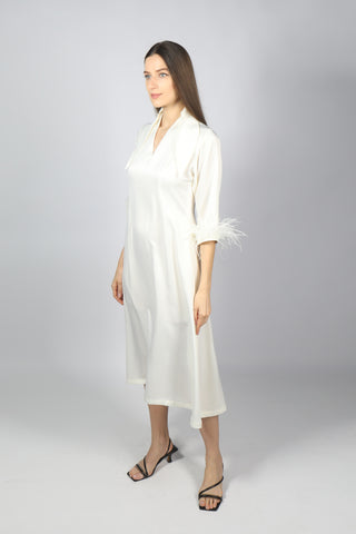 Woman posing in white satin midi dress