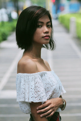 Woman posing with white ruffled top