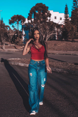 Woman wearing wide-leg jeans and a crop top