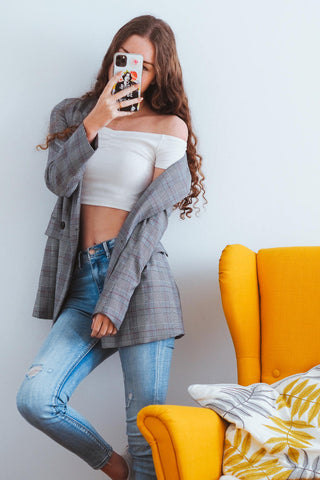 girl posing in crop top and jeans