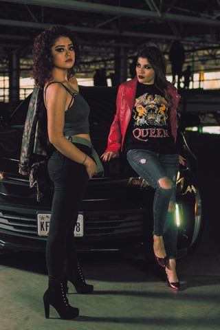 Two women posing with rock style clothes