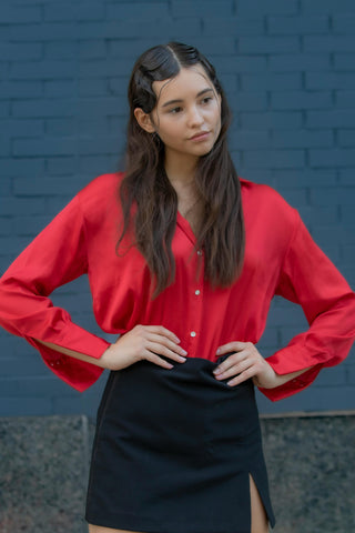 Young woman posing with a mini skirt and a red shirt