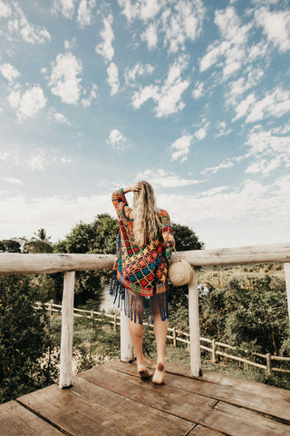 Back photo of a girl wearing a colorful poncho