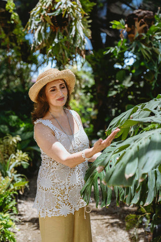 Photo of a woman wearing a crochet top and a wide-brimmed hat