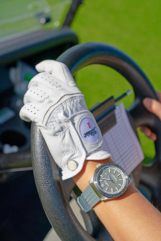 Photo of a golf glove of a person driving a golf cart