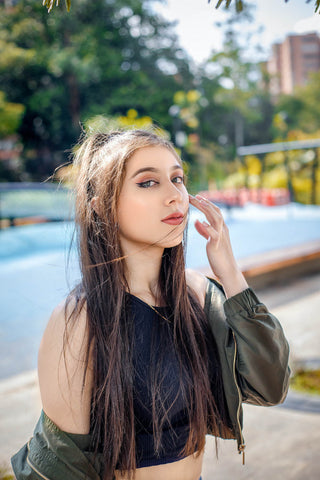 Girl posing with a lightweight jacket and a crop top