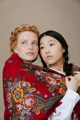 Close photo of two women wearing a shawl